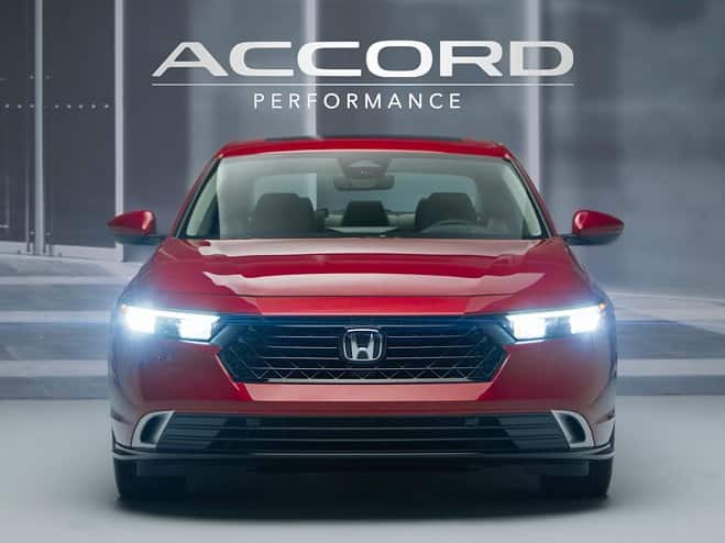 Rear shot of 2026 Honda Accord front view in Radiant Red Metallic showing LED lights on.
